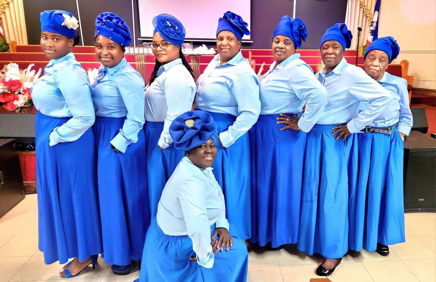 Joyful Haitian congregation worshiping with hands raised in golden light